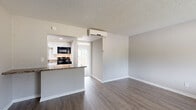 Located at 701 E Bay Drive in Largo, Florida, this single-floor, one-bedroom, one-bathroom unit offers a practical and well-organized layout. The living room serves as the main gathering space, featuring durable wood-look vinyl plank flooring, neutral gray walls, a textured ceiling, and a dedicated entry door with a smart lock. A pass-through counter connects the living area to the kitchen, adding functional convenience. Natural light enters through a large window, contributing to a bright and open feel throughout. The bedroom is a comfortable, carpeted retreat with access to a closet and a connecting door to the hallway. Sliding glass doors open to an outdoor area, allowing additional natural light and outdoor access. The bathroom is clean and straightforward, equipped with a full-size soaking tub and shower combo, a toilet, towel bar, and wood-look flooring that coordinates with the rest of the unit. Soft, neutral tones are carried throughout the space, creating a cohesive and calm aesthetic. The closet provides dedicated storage, contributing to the overall functionality of the unit. This well-laid-out space is ideal for those seeking a manageable, low-maintenance residence in the Largo, FL area.