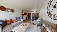 Located at 1233 Jackson St in Stoughton, Wisconsin, this single-floor unit offers a well-designed layout that balances comfort and functionality. The open-concept living and dining area is a central highlight, featuring wood-look flooring, a ceiling fan with light fixture, and a large sliding glass door that floods the space with natural light and provides views of the surrounding greenery. The living area is generously proportioned, offering ample room for relaxed seating arrangements.

Adjacent to the living space, the dining area flows seamlessly and shares the same warm flooring, making the combined area feel cohesive and inviting. The kitchen is efficiently laid out with rich dark cabinetry, granite-style countertops, stainless steel appliances including a refrigerator, microwave, and range, and a breakfast bar that opens toward the main living area.

The unit features two bedrooms, both carpeted for comfort. The primary bedroom includes a ceiling fan, a window for natural light, and direct access to a closet. The secondary bedroom is cozy and equally well-lit. The full bathroom is finished with dark wood cabinetry, a granite-style vanity top, a tub-shower combination, and light wood-look flooring, providing a clean and practical space.