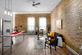 Located at 123 King St in downtown London, Ontario, this one-bedroom, one-bathroom unit offers a thoughtfully designed layout with a distinct character defined by its signature exposed yellow brick walls. Light hardwood flooring runs throughout, complementing the bright, clean aesthetic of the space.

The entryway hallway welcomes you with recessed lighting, mirrored closet doors that enhance the sense of space, and a glimpse of the charming brick feature wall at the end of the corridor. The kitchen is well-appointed with white shaker-style cabinetry, stainless steel appliances including a gas range, over-the-range microwave, and full-size refrigerator, as well as a pendant light fixture above a stainless steel dining table. The kitchen opens to the main living area, where large windows allow natural light to fill the room against the warm exposed brick backdrop.

The bedroom is a cozy retreat featuring a prominent exposed brick accent wall, mirrored sliding closet doors that amplify the room's depth, and a ceiling light fixture. The bathroom includes white cabinetry with ample storage, a dark granite countertop vanity, tile flooring, and a brick-framed mirror, tying in the space's signature architectural detail. This unit blends industrial charm with modern comfort seamlessly.