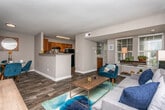 Located at 1955 Bells Ferry Rd in Marietta, Georgia, this single-floor residence offers a thoughtfully designed layout with a comfortable, functional feel throughout. The living room serves as the heart of the home, featuring wood-style flooring, neutral gray walls, and generous natural light streaming through window-fitted white blinds. The space is well-proportioned and inviting, with a warm, contemporary ambiance.

The kitchen is equipped with rich wood cabinetry, granite-style countertops, and black appliances including an electric range, dishwasher, and refrigerator. Wood-look flooring carries through this area, adding continuity and easy maintenance.

The bedrooms are carpeted and feature neutral tones, white-trimmed windows with blinds that allow for natural light, and ample space for furnishings. One bedroom includes a ceiling fan and direct access to a closet and an adjoining bathroom, offering added convenience and privacy.

The bathrooms are finished with warm wood vanities, white countertops, large framed mirrors, and shower-tub combinations with curtain enclosures. Textured gray walls lend a clean, consistent aesthetic throughout the wet areas.

Overall, this residence presents a practical and comfortable living environment with cohesive finishes, functional spaces, and a layout suited for everyday living in the Marietta, GA area.