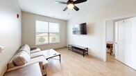 Located at 1222 Patrick Henry Drive in Blacksburg, VA, this well-appointed 4-bedroom, 5-bathroom unit offers a thoughtfully designed single-floor layout. The open-concept kitchen and living area serves as the heart of the home, featuring rich dark cabinetry, granite countertops, stainless steel appliances, and a large breakfast bar with pendant lighting — ideal for casual dining and entertaining. Light wood-style flooring flows throughout, complementing the neutral, warm color palette.

The living room provides a bright and comfortable retreat, with a large window offering pleasant outdoor views, a ceiling fan, and ample space for seating. Each bedroom is well-sized, featuring ceiling fans or dedicated lighting, windows that bring in natural light, and easy access to one of the five bathrooms. Several bedrooms include a study area with a desk, catering to a productive home environment. The bathrooms are clean and consistently finished with tub-shower combinations and brushed nickel fixtures.

A connecting hallway links all areas efficiently, supporting a functional flow throughout the unit. The consistent use of light tones, wood-style flooring, and modern fixtures gives the entire space a cohesive, contemporary feel suited for comfortable everyday living in Blacksburg.