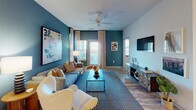 Located at 2818 Barrow Rd in Charlotte, NC, this thoughtfully designed single-floor residence offers a cohesive blend of modern style and comfortable functionality throughout its well-appointed spaces. The open-concept living room makes a strong visual statement with a bold teal accent wall, ceiling fan, large windows that invite natural light, and wood-look flooring that flows seamlessly throughout the home. The kitchen is a functional centerpiece, featuring rich dark cabinetry, granite countertops, stainless steel appliances including a refrigerator, range, and dishwasher, and a peninsula with a sink — ideal for both cooking and casual dining. Adjacent to the kitchen, the dining area provides an intimate setting, complete with decorative wood floating shelves and contemporary wall art. The bedrooms are inviting retreats, each showcasing soft teal accent walls, wood-look flooring, ample natural light from well-placed windows, and tasteful artwork. The primary bathroom offers a spacious walk-in shower with glass sliding doors and built-in shelving, while the secondary bathroom features a full tub-shower combination. Throughout the residence, consistent use of light-toned walls, warm wood-look flooring, and carefully curated design details create a cohesive and welcoming atmosphere.
