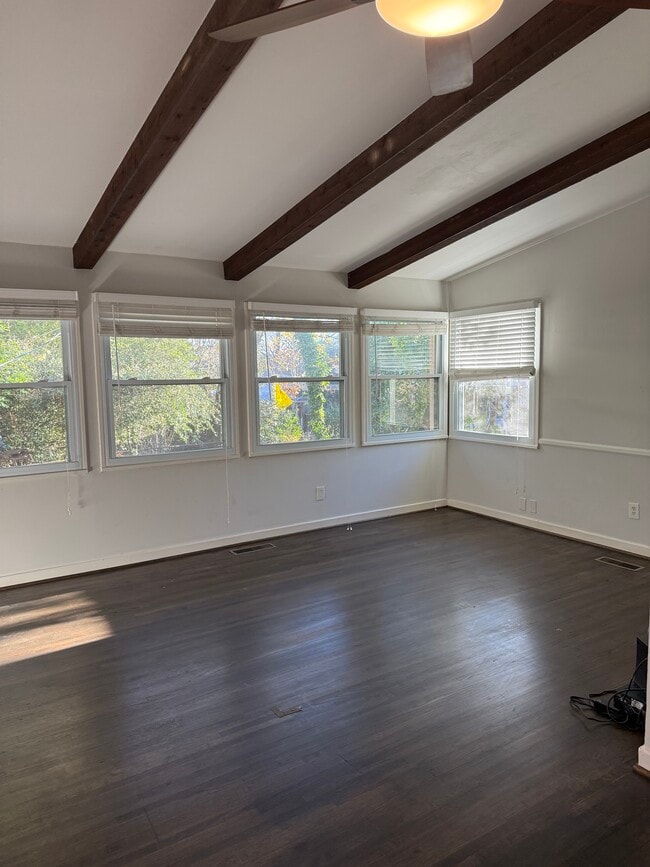Living room with panoramic view of backyard and 12 foot high ceilings with wooden highlights. - 1117 Montclair Rd