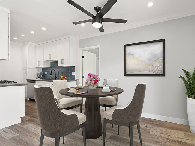 Dining room with hardwood floors, ceiling fan, and view of modern kicthen. - Cedar Glen