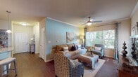 Located at 2000 Toll House Cir in Franklin, Tennessee, this single-floor residence offers a thoughtfully designed layout that balances comfort and functionality. The open-concept living area is anchored by rich hardwood flooring, crown molding, and a ceiling fan, with large windows that invite generous natural light and views of the surrounding greenery. Soft blue accent walls complement the warm, neutral tones found throughout the space.

The kitchen is a standout feature, equipped with dark espresso cabinetry, stainless steel appliances, a subway tile backsplash, and granite countertops that extend to a peninsula with bar seating. Pendant lighting above the peninsula and track lighting overhead add warmth and practicality. A dedicated pantry provides additional storage.

The adjacent dining area is defined by chair-rail molding, hardwood flooring, and a refined ambiance suited for both casual meals and entertaining.

The bedrooms offer a serene retreat with plush carpeting, accent walls, and ample natural light filtered through blinds and curtain panels. The bathrooms feature tile flooring, dark vanity cabinetry with white countertops, and a walk-in shower with sliding glass doors, alongside a dedicated walk-in closet for added convenience.