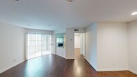 Located at 1417 N Vista Street in Los Angeles, this single-floor residence offers a thoughtfully designed open layout that maximizes both space and functionality. Rich, dark hardwood flooring flows throughout the main living areas, lending warmth and continuity to the interior. The living room is a standout feature, anchored by a tile-surround fireplace with a large mirror accent above, built-in shelving, and floor-to-ceiling mirrored closet doors that visually expand the space. Natural light pours in through a sliding glass door fitted with vertical blinds, which opens to an outdoor area and brightens the entire living space. The kitchen is well-equipped with warm-toned wood cabinetry, granite-look countertops, a white subway tile backsplash, and a double stainless steel sink. A pass-through window connects the kitchen to the living area, enhancing the open feel. The bathroom features tile flooring, a rich wood vanity with granite countertop, a large wall mirror, and clean white fixtures. Throughout the unit, recessed lighting and crisp white walls create a bright, clean aesthetic that complements the warm wood tones and reflects a polished, move-in-ready condition.