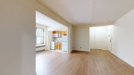 Located at 112 Hoyt St in Stamford, Connecticut, this efficient single-floor unit offers a well-organized layout that maximizes every square foot. The space includes a welcoming entrance that opens into a bright, open living room finished with light hardwood-style flooring and clean white walls, creating a fresh and airy feel. Natural light filters in through a window accompanied by a baseboard heating unit, keeping the space comfortable year-round.

The combined dining and kitchen area is open to the living room and features warm honey-toned oak cabinetry, a gas range, over-the-range microwave, refrigerator, and a single-basin sink — all set atop light tile flooring. A dedicated pantry provides additional storage, complementing the kitchen's functionality.

Two closets offer practical storage solutions throughout the unit. The bathroom is finished with white tile flooring and tiled walls, and includes a vanity with mirror, toilet, and a full bathtub with shower, with a window providing natural ventilation.

The overall layout is thoughtfully arranged, with a clean, neutral palette of whites and warm wood tones lending the space a bright, livable ambiance. Ideal for those seeking a functional and straightforward living space in the heart of Stamford, CT.