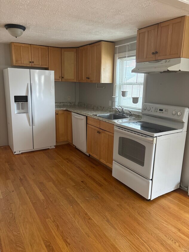 Dishwasher. Plenty of cabinets for storage. Countertops for meal prep. - 27 Elm St