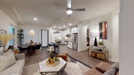 Located at 716–754 Cantegral St in Dallas, TX, this single-story residence offers a thoughtfully designed open-concept layout with contemporary finishes throughout. The living area is anchored by wood-style flooring, a ceiling fan, and recessed lighting, creating a bright and welcoming atmosphere. A corridor connects the living space to private areas, lined with dark-paneled interior doors that add a bold contrast to the light walls.

The kitchen is a standout feature, showcasing white cabinetry, a tiled backsplash, stainless steel appliances, and a dark granite-topped island with bar seating illuminated by industrial-style pendant lights. Adjacent to the kitchen, the dining area benefits from large windows that invite natural light and exterior views, paired with a woven pendant fixture overhead.

The bedroom features a tray ceiling, carpeted flooring, and windows with exterior views, lending a calm, restful ambiance. The en-suite bathroom includes a glass-enclosed walk-in shower, dark granite countertops, and patterned tile flooring. A generously sized walk-in closet with multiple hanging rods and shelving provides ample storage.

Near the entry, a built-in mudroom nook with upper cabinetry and coat hooks offers practical everyday organization.