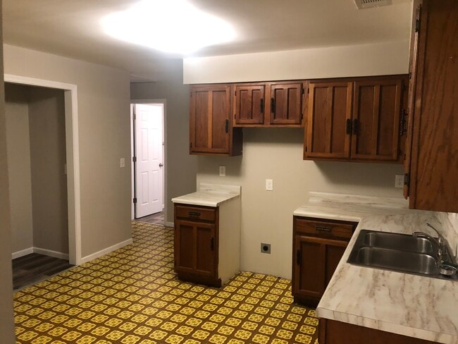 Kitchen includes stainless steel stove and refrigerator - 304 NE 8th St