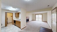 Located at 171 Applegrove St NE in North Canton, Ohio, this single-floor, two-bedroom, two-bathroom home offers a practical and comfortable layout. The open-concept living and dining area is a highlight, anchored by a wood-trimmed fireplace and sliding glass doors that lead to a private patio, filling the space with natural light and providing easy outdoor access. The adjacent kitchen features warm oak cabinetry, a double sink, and tile flooring, with a half-wall partition that maintains a sense of openness while defining the cooking space.

Both bedrooms are carpeted and finished with warm neutral tones, wood-trimmed windows, and rich baseboards. The spacious primary bedroom includes a dedicated closet with bifold doors, while the second bedroom is equally well-sized with its own window view. Each bedroom benefits from its own access to the hallways, which connect the private and shared areas of the home efficiently.

The two full bathrooms are finished with tile flooring and warm oak vanities. One features a walk-in shower, while the other includes a full soaking tub. Three closets throughout the home provide ample storage. A utility room and a dedicated entrance complete this well-organized, single-level floor plan.