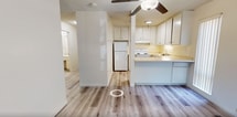 Located at 1410 3rd St in Sacramento, CA, this 780-square-foot apartment offers a practical and comfortable single-floor layout with 2 bedrooms and 2 bathrooms. Throughout the unit, light-toned wood-look laminate flooring provides a clean, cohesive aesthetic complemented by neutral white walls and textured ceilings.

The combined kitchen and living room area serves as the heart of the unit. The living room features a wood-burning fireplace as a focal point, flanked by a window that brings in natural light and views of surrounding greenery. A sliding glass door opens to an outdoor area, enhancing the sense of space. The kitchen is equipped with white cabinetry, a coil-top electric range, refrigerator, dishwasher, and a stainless steel sink, all arranged in an efficient galley-style layout.

The primary bedroom measures a generous 220 square feet and includes a built-in sliding-door closet with a hanging rod. The second bedroom similarly features a spacious closet. A central hallway connects both bedrooms to the two bathrooms and a dedicated closet, ensuring a logical and private flow throughout the unit. Natural light filters into the bedrooms via vertical-blind-covered windows, completing this well-organized Sacramento apartment.