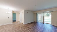 Located at 3901 Noyes Cir in Randallstown, MD, this one-bedroom unit offers a well-organized single-floor layout that makes efficient use of its space. Throughout the unit, durable hardwood-style flooring provides a clean, cohesive look that ties each room together seamlessly.

The living room is the heart of the unit, featuring a sliding glass door dressed with vertical blinds that opens to an outdoor view, allowing natural light to pour in and creating a bright, airy atmosphere. A chandelier adds a touch of elegance to the space.

The kitchen is thoughtfully designed with warm-toned wood cabinetry lining both sides of the galley-style layout, offering generous storage and counter space. White appliances — including a coil-top range, overhead microwave, dishwasher, and refrigerator — provide all essential functions. A skylight-style ceiling fixture and a window at the far end of the kitchen keep the space well-lit.

The bedroom is a comfortable, well-proportioned room with a large window that frames an outdoor green view, providing natural light throughout the day. A dedicated closet with double doors offers practical storage. The unit also includes additional closet space near the entryway, maximizing storage throughout.