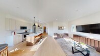 Located at 1101 Stillwater Dr in Lake Orion, Michigan, this single-story home offers a well-organized, efficient layout across one level. The open-concept living, dining, and kitchen area serves as the heart of the home, filled with natural light from large windows that frame outdoor views. The kitchen is equipped with stainless steel appliances, floor-to-ceiling white shaker cabinetry, a warm walnut-toned island, quartz countertops, and light hardwood flooring, all accented by modern pendant lighting. The adjacent dining area features a bright window overlooking a green landscape, creating a pleasant setting for everyday meals. The living room offers a welcoming, light-filled space with recessed lighting and direct access to the front entry. The primary bedroom is a comfortable retreat with plush carpeting and a stylish sliding barn door that opens to a dedicated closet. Two full bathrooms are finished in a clean, modern aesthetic with white two-panel doors and matte black hardware. A dedicated office with carpet flooring and a large window provides a functional workspace. The laundry room includes a full-size Whirlpool washer and dryer with overhead cabinetry for added storage. The attached garage is bright and clean with direct interior access, completing this well-appointed home.