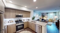 Located at 523 W Crowther Ave in Placentia, CA, this thoughtfully designed 2-bedroom, 1-bathroom residence makes excellent use of its compact footprint across a single floor. The open-concept layout seamlessly connects the kitchen and living area, creating a cohesive and functional living space.

The kitchen is a standout feature, outfitted with warm wood-tone cabinetry, a crisp white subway tile backsplash, light quartz countertops, and a full suite of stainless steel appliances including a gas range, built-in microwave, dishwasher, and refrigerator. Recessed lighting and under-cabinet illumination enhance the modern aesthetic. A peninsula counter connects the kitchen to the living area, offering both workspace and a casual dining option.

The living room is bright and inviting, benefiting from a large window that draws in natural light. Wood-style flooring runs throughout the main areas, adding warmth and continuity.

The primary bedroom is a comfortable retreat, highlighted by a dramatic deep-blue accent wall and a generous window with outdoor views. The second bedroom and a well-appointed closet offer practical storage solutions. The full bathroom features a tub-shower combination, wood-tone vanity, light countertop, and a large mirror. A carpeted hallway connects the private areas of the residence, maintaining a clean and organized flow throughout.