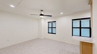 Located at 101 N Broadway Ave in the heart of downtown Oklahoma City, this efficiently laid-out single-floor unit offers a well-considered mix of rooms designed to maximize functionality within a compact footprint. The entrance leads into a bright, open living room finished with light gray carpet, recessed lighting, and black-framed windows that invite natural light. A sleek ceiling fan with an integrated light fixture adds both style and comfort to the space.

The galley-style kitchen is a standout feature, showcasing light wood cabinetry with brushed gold hardware, crisp white quartz countertops, a double stainless steel sink with a gold-tone faucet, and a tasteful tile backsplash in muted blue-gray tones. Black stainless appliances, including a range and refrigerator, complete the functional setup.

The bathroom is elegantly appointed with marble-look tile surrounding a soaking tub and shower combination, brass fixtures, a classic penny-tile floor, a light wood vanity with a dark countertop, and black-framed hardware throughout. A dedicated laundry area and a spacious closet with paneled white doors and gold lever handles provide practical storage and utility options. The consistent use of warm wood tones, gold accents, and clean white walls throughout creates a cohesive, modern aesthetic.