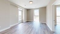 Located on the 18th floor at 195 Dundas Street in downtown London, Ontario, this 2-bedroom, 1-bathroom unit offers a well-designed layout with modern finishes throughout. Light grey laminate flooring and warm neutral tones flow consistently across the entire space, creating a cohesive and contemporary atmosphere.

The open-concept kitchen and living area serves as the heart of the unit. The kitchen is outfitted with crisp white cabinetry, grey quartz countertops, a classic subway tile backsplash, stainless steel appliances, and a central island with pendant lighting overhead — ideal for both cooking and casual dining.

The living area benefits from multiple floor-to-ceiling windows that frame expansive views of the London skyline, flooding the space with natural light.

Both bedrooms are comfortably sized with large windows that continue to showcase the city views. The primary bedroom includes a dedicated closet with built-in wire shelving, providing ample storage. A second closet with double panel doors serves the second bedroom.

The bathroom features elegant marble-style tile surrounding a full soaker tub and shower combination, complemented by clean white fixtures and tile flooring.

This unit combines functional design with high-floor urban living in the heart of downtown London.
