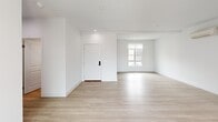 Located at 72 W Santa Clara St in Ventura, California, this two-story residence offers a thoughtfully designed layout spread across two floors. The main level features an open-concept living area bathed in natural light, showcasing clean white walls and light wood-tone flooring that creates a bright, airy atmosphere. A set of sliding glass doors leads to a private balcony, extending the living space outdoors. The kitchen is well-appointed with rich dark cabinetry, stainless steel appliances including a refrigerator, range, microwave, and dishwasher, complemented by light countertops and a window above the sink. Three full bathrooms are distributed throughout the home, each finished in a clean, modern style — one featuring a glass-enclosed tub-shower combination and another with a sleek vanity and wood cabinetry with matte black fixtures. Both bedrooms are carpeted and equipped with wall-mounted mini-split HVAC units for individual climate control. The spacious primary bedroom includes access to a dedicated closet fitted with built-in shelving and dual hanging rods. The second bedroom offers a window with views of the surrounding Ventura hillside. Two staircases connect the floors, adding convenience and flow to the overall layout.
