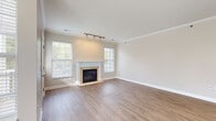 Located at 370 Spaulding Hills Circle in Ada, Michigan, this single-story residence combines functional design with quality finishes throughout. The open living area serves as the heart of the home, showcasing light hardwood-style flooring, crown molding, and a tile-surround gas fireplace flanked by windows that invite natural light. Track lighting overhead adds a modern, adjustable lighting option to the space.

The kitchen features rich, dark wood cabinetry paired with granite countertops, a classic white subway tile backsplash, stainless steel appliances including a range, microwave, and refrigerator, and a double undermount sink. A door off the kitchen provides convenient exterior access.

The bedrooms offer plush carpeting and windows with views of the surrounding greenery, creating a calm and comfortable atmosphere. A dedicated built-in workspace with a granite-topped desk surface and upper shelving provides a practical area for home office use.

Bathrooms are finished with dark wood vanities, white countertops, and hardwood-style tile flooring. One bath includes a tub-shower combo with built-in shelving. A half bath provides additional convenience. Neutral tones and clean lines carry throughout, giving the home a cohesive and move-in-ready appeal.