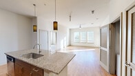 Located at 900 Grange Hall Dr in Euless, TX, this well-appointed 3-bedroom, 2-bathroom residence offers a thoughtfully designed single-floor layout. The open-concept living and kitchen area serves as the heart of the home, where light hardwood-style flooring, soaring ceilings, and a bank of large windows with blinds flood the space with natural light. A ceiling fan anchors the living area, adding comfort and airflow.

The kitchen is outfitted with sleek, dark wood cabinetry extending to the ceiling for ample storage, a classic tile backsplash, granite countertops, and a full suite of stainless steel appliances including a range, over-the-range microwave, and refrigerator. A granite-topped island with an undermount sink adds both workspace and visual appeal.

The spacious primary bedroom features plush carpeting, dual windows with natural light, and a ceiling fan. Its en-suite bathroom offers large-format tile flooring, a granite vanity with dark wood cabinetry, a glass-enclosed shower, and direct access to a generously sized walk-in closet with built-in shelving and hanging rods. The additional bedrooms are bright and carpeted, each served by a well-organized closet with shelving systems. The layout is efficient, functional, and move-in ready.