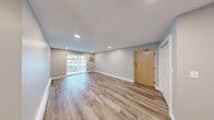 Located at 357 Newport Ave in Quincy, MA, this one-bedroom, one-bathroom unit offers a thoughtfully updated interior with a clean, modern aesthetic throughout. Light-toned hardwood-style flooring runs continuously across the entire floor plan, creating a cohesive and airy feel.

The living room is the largest area of the unit, featuring recessed lighting, neutral gray walls, and a sliding glass door that provides access to the outdoors and brings in natural light. A wall-mounted air conditioning unit and baseboard heating ensure year-round comfort.

The kitchen is well-appointed with white shaker-style cabinetry, dark granite countertops, a subway tile backsplash, and a full suite of stainless steel appliances including a gas range, dishwasher, and refrigerator. A window above the sink adds natural light to the space.

The bedroom is a comfortable, well-proportioned room with recessed lighting, a window with blinds, baseboard heating, and a closet. The neutral color palette keeps the space feeling calm and functional.

The bathroom features a full tub-shower combination with classic white subway tile surround, chrome fixtures, and a window that provides ventilation and natural light. The overall design of this unit reflects modern, move-in-ready finishes throughout.