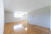 Located at 2250 Kennedy Rd in Toronto's Scarborough district, this single-floor unit offers four bedrooms, two bathrooms, a kitchen, hallway, and closet within a well-organized layout. Polished parquet flooring runs consistently throughout the living areas and bedrooms, adding warmth and a timeless character to the space. The expansive living room is a standout feature, bathed in natural light from large windows that frame views of the surrounding neighbourhood, including greenery and nearby buildings. Its open feel and textured ceiling lend an airy, comfortable ambiance. The kitchen is outfitted with grey cabinetry, granite-style countertops, tile flooring, and ample upper and lower storage, providing a functional and clean workspace. The four bedrooms vary in size, with the primary bedroom offering generous proportions. Several bedrooms benefit from windows with natural light and garden or sky views, while one includes a built-in double closet for added storage. The bathrooms are finished in crisp white tile, featuring a full tub-shower combination and clean, neutral fixtures. A dedicated closet and connecting hallway complete the layout, ensuring practical flow throughout the unit.