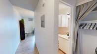 Located at 110 South Almon Street in Moscow, Idaho, this 1-bedroom, 1-bathroom unit offers a practical and efficient layout across a single floor. Light wood-style flooring runs throughout, creating a cohesive and clean aesthetic in every room.

The open-concept main area seamlessly combines the living room, dining space, and kitchen. The living room features a large window that brings in generous natural light, complemented by a wall-mounted air conditioning unit and baseboard heating. The kitchen is outfitted with white cabinetry, a white electric range, refrigerator, and additional counter space, with a window providing added brightness. A dining area sits adjacent to the kitchen, completing this functional shared space.

The hallways connect the main living area to the private quarters, with an electrical panel accessible along the corridor. The bedroom is a comfortable, well-lit retreat with a window overlooking the exterior, baseboard heating, and a textured ceiling. The full bathroom includes a vanity with white cabinetry, a mirror cabinet, and a shower-tub combination with a curtain enclosure.

Throughout the unit, white walls and textured ceilings maintain a bright, neutral palette, making the space feel open and easy to personalize.