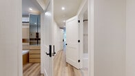Located at 535 Glenrock Ave, this thoughtfully designed 4-bedroom, 2-bathroom single-floor residence offers a clean, modern aesthetic throughout. The open layout is unified by light hardwood flooring and a soft neutral color palette that creates a bright, cohesive atmosphere.

The kitchen is a standout feature, showcasing light wood cabinetry extending to the ceiling, white quartz countertops, a subtle textured tile backsplash, and a full suite of stainless steel appliances including a refrigerator, range, microwave, and dishwasher. A round dining table with upholstered chairs sits adjacent, making the space ideal for everyday meals.

The living area provides a welcoming retreat, anchored by a plush modular sectional sofa and a sleek coffee table. Windows allow natural light in, with one room offering direct outdoor access through a panel door.

The four bedrooms are outfitted with light wood platform beds, built-in storage, and individual mini-split climate control units. Several rooms feature integrated shelving and wardrobe systems with mirrored panels, maximizing both function and light.

Both bathrooms reflect a modern spa-like sensibility, featuring terrazzo-style tile flooring, wall-mounted vanities with warm wood drawers, mirrored medicine cabinets, and contemporary fixtures with matte black accents. One bathroom includes a soaking tub with a tiled shower surround.