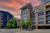 This contemporary 1-bedroom apartment, located at 1950 Howell Mill Rd NW in Atlanta, GA, offers 660 square feet of efficiently designed living space. The heart of the home is the stylish kitchen, boasting dark cabinetry contrasted with white subway tile backsplash, granite countertops, and a full suite of stainless steel appliances. The open layout seamlessly connects to the living area, which is illuminated by track lighting and features warm wood-look flooring.

The spacious 150 square foot bedroom is carpeted for comfort and includes a ceiling fan and window for natural light. A generously sized closet with wire shelving provides ample storage. The modern bathroom showcases a granite-topped vanity, large mirror, and a combination tub-shower with neutral tile surround.

Throughout the apartment, crisp white walls and trim create a bright, airy atmosphere. The unit is equipped with modern amenities such as central air conditioning and in-unit laundry hookups. This well-designed space offers a perfect blend of style and functionality for comfortable urban living.