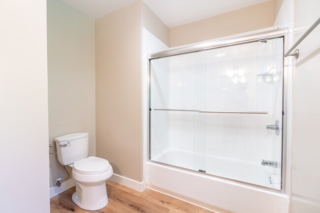 Spacious bathroom with pristine glass sliding door - 2620 Regent