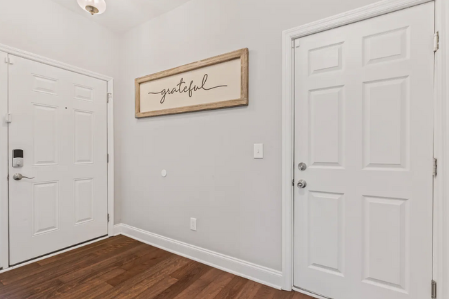 Entry Hallway with half bathroom for guest use. Hooks for jackets and the second entry door. - 532 Paragon Mills Rd