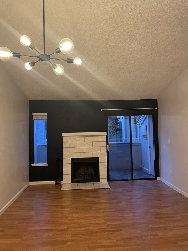 living room with balcony door - 250 Del Verde Cir Apartment