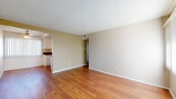 Located at 154 N Palmetto Ave in Ontario, CA, this one-bedroom, one-bathroom unit offers a practical and well-organized layout across a single floor. Warm hardwood-style flooring flows consistently throughout the space, creating a cohesive and inviting atmosphere. The living room is bright and open, benefiting from natural light admitted through a large window dressed with vertical blinds, and features a textured ceiling that carries through the entire unit.

The layout connects the living area to a dedicated dining space, which opens into a galley-style kitchen. The kitchen is efficiently designed with white cabinetry lining both sides, dark granite countertops, a double-basin sink, and white appliances including a range, microwave, refrigerator, and dishwasher.

The bedroom is a comfortable size, equipped with a ceiling fan with light fixture, a window for natural light, and access to two closets — one of which is a walk-in. A connecting hallway leads to a utility room, providing additional functional space.

The bathroom features a granite-topped vanity with white cabinetry, a full tub-shower combination, and a window for natural ventilation. Throughout the unit, neutral beige tones and clean white trim contribute to a simple, understated aesthetic.