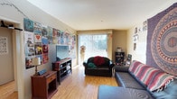 This single-floor residence offers three bedrooms and three bathrooms, providing ample space for comfortable living. The living room serves as the heart of the home, featuring warm hardwood flooring that extends throughout the space and smooth white ceilings that contribute to a bright, open atmosphere. A large sliding glass door floods the room with natural light and provides direct access to an outdoor area, enhancing the sense of openness. The living room offers generous room for seating arrangements and entertainment setups, with wall space that lends itself well to personalization and décor. The layout is practical and well-proportioned, with a functional flow between the main living areas. The three bathrooms provide excellent convenience for residents and guests alike, while the three bedrooms offer flexible options for sleeping quarters, home offices, or additional living space. The overall design of the home is straightforward and functional, with clean lines and neutral tones that create a versatile backdrop suitable for a variety of interior styles. Natural light is a notable feature throughout, contributing to a welcoming and comfortable ambiance across the entire floor plan.