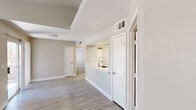 Located at 9620 W Russell Rd in Las Vegas, NV, this 2-bedroom, 2-bathroom residence offers a well-designed single-floor layout that maximizes functionality. The open-concept living area is anchored by light wood-style flooring, neutral toned walls, and a ceiling fan, creating a bright and airy atmosphere. A sliding glass door allows natural light to pour in while providing outdoor access. The kitchen features white shaker cabinetry, quartz countertops, a subway tile backsplash, stainless steel appliances including a range and built-in microwave, a dishwasher, and a peninsula with a deep stainless steel sink that overlooks the living area. Both bedrooms are carpeted and include ceiling fans and windows that bring in natural light, with the primary bedroom offering a generous footprint. Each bathroom is finished with a white vanity, vessel-style sink, quartz countertop, and a tub-shower combination. Additional highlights include a dedicated in-unit laundry area with washer and dryer hookups and overhead shelving, two closets for ample storage, and a hallway connecting the living spaces. The overall aesthetic is clean, modern, and move-in ready.