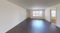 This single-story, 4-bedroom, 4-bathroom home offers a well-designed layout that balances open communal spaces with comfortable private quarters. The living area is generously sized, featuring rich, dark hardwood-style flooring that flows seamlessly into the kitchen, creating a cohesive and inviting atmosphere. The kitchen is fully equipped with warm honey-toned wood cabinetry, dark granite-style countertops, a double sink, and a full suite of black appliances including a range, microwave, dishwasher, and refrigerator. A window above the sink brings in natural light, brightening the workspace.

Each of the four bedrooms is finished with plush wall-to-wall carpeting and neutral cream-toned walls, providing a clean and comfortable retreat. Multiple bedrooms feature windows with blinds, allowing for natural light and ventilation. The bathrooms are practical and well-appointed, each featuring a soaking tub and shower combination with clean white surrounds, warm wood vanities with white countertops, framed mirrors, and hardwood-style flooring. One bathroom also includes a convenient built-in towel bar and closet access. Throughout the home, consistent neutral finishes and a straightforward, functional design make this a versatile and move-in-ready space.