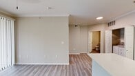 This 580-square-foot, one-bedroom, one-bathroom apartment at Lakeline Villas in Cedar Creek, TX offers a well-designed, single-floor layout with modern finishes throughout. Light wood-look flooring flows consistently across every room, complementing the neutral gray and white color palette that gives the unit a clean, contemporary feel.

The kitchen is a standout feature, boasting white shaker cabinets, white subway tile backsplash, and a full suite of stainless steel appliances including a refrigerator, electric range, and over-the-range microwave. A peninsula with a white countertop and undermount sink with a matte black faucet provides additional prep space and separates the kitchen from the living area. A dedicated utility alcove houses an in-unit washer and dryer for added convenience.

The 140-square-foot primary bedroom features elevated ceilings, a ceiling fan, a large window with blinds that allow natural light, and access to two closets offering ample storage. The bathroom continues the modern aesthetic with a white vanity, white countertop, undermount sink, and matte black hardware accents, all set on matching wood-look flooring. The open layout and consistent finishes create a cohesive, move-in-ready living space.