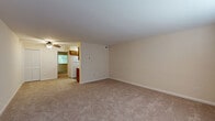Located at 1602 Finch Pl in Lyndon, KY, this one-bedroom, one-bathroom apartment delivers a well-organized single-floor layout with a functional use of space throughout. The open living room features wall-to-wall carpeting, neutral beige walls, and a ceiling fan with light fixture, creating a bright and airy atmosphere. It flows seamlessly into the kitchen, which is equipped with wooden cabinetry and standard appliances including a refrigerator, offering a practical cooking and dining area. The bedroom is a generously sized retreat with plush carpeting, a ceiling fan, a window with blinds allowing natural light and views of surrounding greenery, and a closet with bifold doors. Additional closet space is plentiful throughout, with four closets total providing excellent storage. The bathroom includes a full tub-shower combo, a toilet, and a vanity with wood cabinetry, finished in clean, neutral tones with tile flooring. Throughout the apartment, the consistent use of soft beige tones and carpeted floors creates a cohesive and comfortable ambiance, well-suited for everyday living.