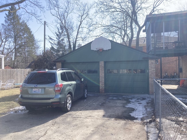 Driveway, garage, basketball hoop, and screen porch. - 1312 Brooklyn Ave