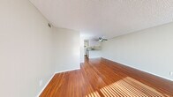 Located at 1628 Bell St in Arcade, CA, this 2-bedroom unit is laid out entirely on a single floor, offering a practical and comfortable living arrangement. The open living area is finished with rich hardwood-style flooring that extends throughout the main spaces, complemented by neutral-toned walls and a textured ceiling. A large front-facing window floods the living room with natural light, creating a bright and welcoming atmosphere. A ceiling fan is centrally positioned over the living and dining area, providing both function and visual balance. The kitchen features a breakfast bar peninsula, gray laminate countertops, white cabinetry, and includes a full-size refrigerator and dishwasher, with wood-look flooring tying it seamlessly into the rest of the main living space. The bathroom is efficiently arranged with a vanity featuring gray countertops, a mirrored medicine cabinet, and a separate water closet. Both bedrooms are carpeted for added comfort, each offering generous proportions, large windows with vertical blinds that invite natural light, and ample closet space — one bedroom includes a walk-in closet. The overall design is clean, neutral, and move-in ready, with a cohesive aesthetic throughout.