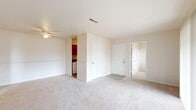 This single-floor residence at 144 Rutledge Dr in Salem, VA offers a practical and efficient layout across three bedrooms, one bathroom, and a kitchen. The interior is finished with neutral-toned carpet throughout the living and bedroom areas, complemented by clean white walls that create a bright, cohesive aesthetic.

The living area features a ceiling fan and connects to the main entry, where two interior doors lead to a hallway and additional rooms. A sliding glass door in the primary bedroom—the largest of the three—floods the space with natural light and provides an outdoor view, with vertical blinds offering privacy. The primary bedroom is notably generous in size relative to the overall footprint of the home.

The secondary bedrooms are carpeted and well-lit, with one room featuring two windows on adjacent walls, maximizing natural light. Each bedroom includes or has access to closet storage.

The kitchen is galley-style, equipped with warm wood cabinetry, dark laminate countertops, a double-basin sink, a gas range, dishwasher, and refrigerator, all set over tile flooring. The bathroom includes a full-size soaking tub with a clean white surround. A washer connection is visible near the kitchen area, adding functional utility to the space.