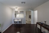 Located at 250 Wilkerson Ave in Perris, California, this single-floor residence offers a well-organized layout that balances comfort and functionality. Rich, dark hardwood flooring runs throughout the main living areas, providing a warm and cohesive aesthetic against the light-toned walls.

The living and dining area is an open, inviting space highlighted by a ceiling fan with integrated lighting, a textured ceiling, and a window dressed with floor-length curtains that allow natural light to filter in. The area flows seamlessly into the kitchen through a pass-through opening, enhancing the sense of openness.

The kitchen is efficiently designed with gray-toned cabinetry, granite-style countertops, a gas range, and an under-cabinet range hood. Tile flooring and recessed lighting give the kitchen a clean, practical feel with ample cabinet storage.

The bedroom is a comfortable retreat featuring the same dark hardwood flooring, a ceiling fan, and direct access to both a bathroom and a laundry area, adding exceptional convenience. The layout offers generous closet access via a curtained entry.

The bathroom is neatly appointed with tile flooring, a single-sink vanity with a framed mirror, and a tub-shower combination, providing all essential amenities in a tidy, well-maintained space.