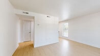 Located at 3227 S Parker Rd in Denver, CO, this one-bedroom, one-bathroom unit offers a thoughtfully arranged single-floor layout. The combined kitchen and living area features light wood-style flooring throughout, creating a clean and cohesive aesthetic. The kitchen is equipped with warm-toned wood cabinetry, ample upper and lower storage, and a marble-style countertop that extends generously along the wall, providing significant prep and workspace. A sink anchors the left side of the kitchen, and multiple outlets are conveniently positioned along the backsplash. The adjacent living area is open and bright, benefiting from a large window fitted with horizontal blinds that allows natural light to fill the space. The bedroom is comfortably sized and finished with plush carpeting. It includes a double-door closet offering practical storage, along with a window that brings in additional natural light. The bathroom features a wood-cabinet vanity with a marble-style countertop, a framed mirror, a full tub-shower combination with white tile surround, and light wood flooring consistent with the rest of the unit. The overall design is clean, neutral, and move-in ready, with a straightforward layout suited for efficient everyday living.
