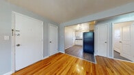 Located at 72 Folly Brook Blvd in Wethersfield, CT, this single-floor unit offers a well-designed layout with consistent finishes throughout. Warm hardwood flooring flows through the main living areas and bedrooms, complemented by soft gray walls that create a clean, neutral ambiance.

The open living and dining area is bright and welcoming, featuring a modern orbit-style pendant light fixture and large windows that invite natural light. The space connects seamlessly to the kitchen, which has been thoughtfully updated with white shaker cabinetry, granite-style countertops, a white tile backsplash, and stainless steel appliances including a range, microwave, and refrigerator. A window above the sink adds additional natural light to the cooking space.

The bedrooms are generously proportioned, each with hardwood floors, large windows overlooking the outdoors, and baseboard heating. One bedroom features a closet and direct access to the bathroom.

The bathroom is a standout, showcasing dark slate-style tile on both the floor and tub surround, paired with a sleek navy vanity with white countertop and modern fixtures, offering a contemporary and polished aesthetic.

Multiple interior doors provide privacy and organization throughout, making this a functional and attractively finished single-level space.
