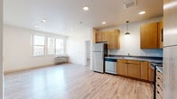 Located at 1440 Independence St in Lakewood, Colorado, this single-floor, 3-bedroom, 2-bathroom residence offers a well-organized and functional layout designed for comfortable everyday living. Light wood-look flooring runs throughout the space, creating a cohesive and modern aesthetic from room to room.

The kitchen is a standout feature, boasting warm wood cabinetry that extends to the ceiling for ample storage, a striking turquoise tile backsplash, stainless steel appliances including a range, built-in microwave, dishwasher, and refrigerator, and a pendant light fixture that adds a contemporary touch over the workspace.

Three bedrooms provide comfortable accommodations, with the primary bedroom offering a generous footprint and direct access to a bathroom. Each bedroom features the same light wood-look flooring and neutral white walls, with windows that bring in natural light and views of the surrounding area.

Both bathrooms are consistently finished, each featuring a full tub-shower combination, wood-toned vanity cabinetry, and light flooring. A central hallway connects the rooms efficiently, with modern gray panel doors throughout adding a sleek, uniform character to the interior. A dedicated closet provides additional storage. The overall ambiance is clean, bright, and move-in ready.