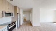 Located at 75 Braintree St in Boston's Allston neighborhood, this modern 3-bedroom, 1-bathroom residence offers a bright, contemporary living experience across a single floor. Light wood-grain luxury vinyl flooring flows consistently throughout every room, tying the space together with a clean, cohesive aesthetic.

The kitchen is appointed with flat-front light wood cabinetry, stainless steel appliances including a refrigerator, range, microwave, and dishwasher, complemented by a white mosaic tile backsplash and recessed lighting. The layout transitions naturally into a hallway leading to all three bedrooms and the bathroom.

The spacious living room is a standout feature, boasting oversized windows that frame views of the surrounding Boston cityscape and fill the room with natural light. A ceiling fan adds both function and comfort to the generous open space.

The primary bedroom is notably expansive, featuring large windows and a full closet. The two additional bedrooms are well-proportioned, each with light-filled windows and light flooring. The shared bathroom includes a full shower-tub combination with clean white finishes and tile flooring. The overall ambiance of this residence is fresh, modern, and move-in ready.
