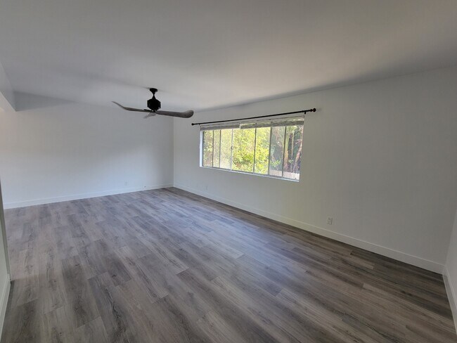 Large living room space with decorator ceiling fan. new wood floors & new cordless blinds - 1451 12th St