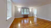 Located at 697 Eglinton in Toronto's sought-after M5P neighbourhood, this well-appointed 2-bedroom, 1-bathroom unit blends classic architectural character with functional living. Warm hardwood floors flow throughout the space, complemented by crisp white crown molding and traditional six-panel doors that lend a timeless charm to every room.

The combined living and dining area is generously proportioned, featuring large multi-pane windows that invite natural light and frame lush outdoor greenery. Cast-iron radiators underscore the building's heritage character. A distinctive arched passageway connects the hallway to the main living space, adding an elegant architectural touch.

The kitchen is finished with white cabinetry, a classic subway tile backsplash, light countertops, and tile flooring, providing a clean and practical workspace. Three closets are distributed throughout the unit, ensuring ample storage.

Both bedrooms are comfortably sized, each with gleaming hardwood floors, crown molding, and windows overlooking the outdoors. The primary bedroom offers a notably spacious footprint. The full bathroom includes a tub/shower combination with grab bars, a vanity with under-sink storage, and tile finishes throughout. A central hallway connects all rooms efficiently, completing this well-organized and characterful unit.