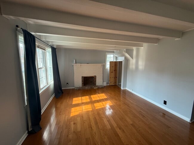 Living room with non-working fireplace and closet - 1624 Porter Ave