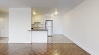 This contemporary 580 square foot apartment offers a thoughtfully designed living space. The open-concept layout seamlessly integrates the kitchen, living, and dining areas, creating a sense of spaciousness. The kitchen features sleek white cabinetry, subway tile backsplash, and stainless steel appliances, including a full-sized refrigerator. A peninsular counter with an overhang provides additional workspace and casual dining options.

The living area is characterized by its parquet flooring, which extends throughout the apartment, adding warmth and character. Large windows flood the space with natural light and offer views of the surrounding area. The bedroom, measuring 140 square feet, includes a mirrored closet door, maximizing the perception of space.

The bathroom showcases a clean, modern design with white subway tiles from floor to ceiling, creating a bright and hygienic environment. A standard bathtub with a shower fixture offers versatility for personal preferences.

Practical features include ceiling-mounted light fixtures and baseboard heating units. The neutral color palette throughout the apartment provides a blank canvas for personal decorating styles. This well-appointed space efficiently utilizes its 580 square feet to offer comfortable urban living in Mississauga.